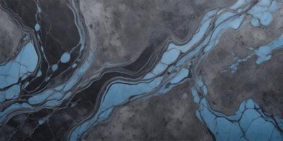 The primary subject of the image is a blue and grey marble tile. The setting is a grey stone wall, and the visual style is a close-up of the tile. The colors and mood of the image are predominantly blue and grey, creating a calm and sophisticated atmosphere.