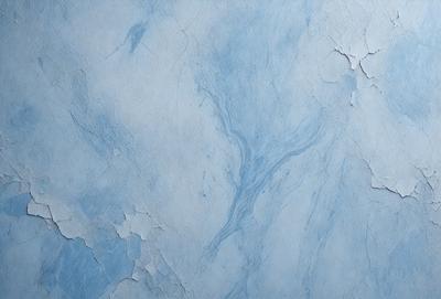 The primary subject of the image is a blue marble wall with a pattern of swirls. The setting is a room with a blue marble wall, and the visual style is a photo. The dominant colors are blue and white, creating a calm and serene atmosphere.