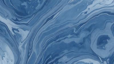 The primary subject of the image is a blue and white ocean wave. The setting is the ocean, with the wave crashing against the surface. The visual style is a photo of the ocean, capturing the beauty and power of the wave. The dominant colors are blue and white, creating a serene and calming atmosphere.