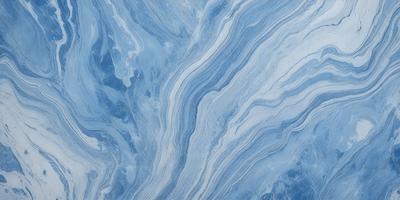 The primary subject of the image is a blue and white marbled tile. The setting is a wall with the tile as the main object. The visual style is a close-up of the tile, showcasing its intricate design. The dominant colors are blue and white, creating a calm and soothing atmosphere.