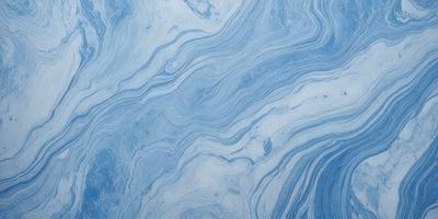 The primary subject of the image is a blue and white swirling pattern, which appears to be a part of a larger blue and white design. The setting is a blue and white surface, possibly a wall or a piece of artwork. The visual style of the image is a close-up of the swirling pattern, showcasing its intricate details. The colors and mood of the image are predominantly blue and white, creating a sense of calmness and elegance.