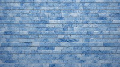 The primary subject of the image is a blue brick wall. The setting is a room with a blue brick wall as the main focus. The visual style is a photo of the blue brick wall. The dominant colors are blue and white, creating a calm and soothing atmosphere.