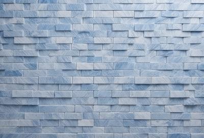 The primary subject of the image is a blue marble wall with a pattern of blue and white tiles. The setting is a room with a blue marble wall as the main focus. The visual style is a close-up of the blue marble wall, showcasing the intricate pattern of the tiles. The colors and mood of the image are predominantly blue, creating a calm and serene atmosphere.