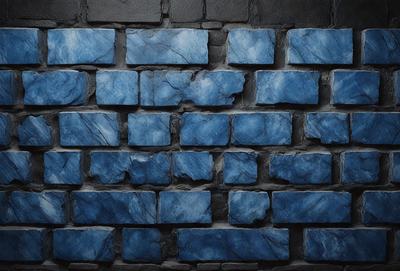 The primary subject of the image is a blue brick wall. The setting is a stone wall, and the visual style is a photo. The dominant colors are blue and gray, creating a calm and serene atmosphere.