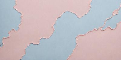 The primary subject of the image is a piece of paper with a cut-out design, resembling a piece of fabric. The paper is placed on a pink surface, which serves as the setting. The visual style of the image is a combination of digital art and illustration, as the paper appears to be digitally manipulated. The colors in the image are predominantly pink and blue, creating a warm and inviting atmosphere.