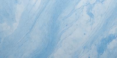 The primary subject of the image is a blue and white marbled surface, which appears to be a wall or a countertop. The setting is a room with a blue and white marbled wall, and the visual style is a close-up of the marbled surface. The colors and mood of the image are predominantly blue and white, creating a calm and serene atmosphere.
