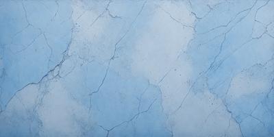 The primary subject of the image is a blue wall with a cracked and chipped appearance. The setting is a room with a blue background. The visual style is a close-up of the wall, showcasing its texture and imperfections. The colors and mood of the image are predominantly blue, creating a calm and serene atmosphere.