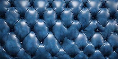 The primary subject of the image is a blue couch with a patterned design. The setting is a room with a blue background, and the visual style appears to be a photo. The dominant colors in the image are blue and white, creating a calm and relaxing atmosphere.
