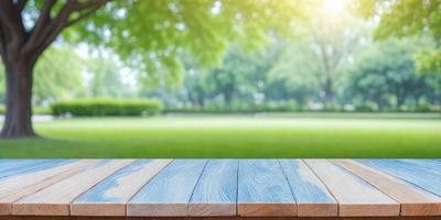 The primary subject of the image is a wooden bench with a blue and wood grain design. The bench is situated in a grassy field, providing a comfortable spot for relaxation. The setting is a park with trees in the background, creating a serene and natural atmosphere. The visual style of the image is a combination of photo and digital art, giving it a unique and artistic appearance. The dominant colors are blue and wood grain, which complement the natural surroundings of the park.