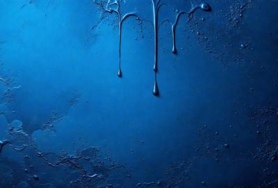 The primary subject of the image is a blue background with three drops of water, each with a different size and shape, hanging from the top of the background. The setting is a dark blue surface, possibly a wall or a piece of artwork. The visual style appears to be a combination of a photo and a digital artwork, as the drops of water are depicted in a realistic manner, while the overall atmosphere is somewhat surreal due to the unusual arrangement of the drops. The colors and mood of the image