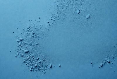 The primary subject of the image is a blue surface with a pattern of bubbles or droplets on it. The setting appears to be a blue background, and the visual style is a close-up of the blue surface. The colors and mood of the image are predominantly blue, creating a calm and serene atmosphere.