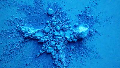 The primary subject of the image is a blue substance, possibly a powder or a liquid, with a star shape. The setting is a blue background, and the visual style appears to be a digital art or illustration. The colors and mood of the image are predominantly blue, creating a calm and serene atmosphere.
