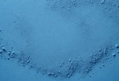 The primary subject of the image is a blue surface with a pattern of bubbles or foam. The setting appears to be a blue background, and the visual style is a close-up of the blue surface. The dominant colors are blue and white, creating a calm and soothing atmosphere.