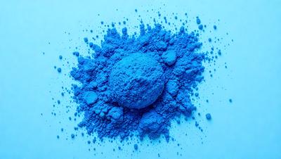 The primary subject of the image is a blue powder, which appears to be a blue paint or a blue substance. The setting is a white background, which provides a clean and uncluttered environment for the blue powder to be the main focus. The visual style of the image is a close-up of the blue powder, showcasing its texture and color. The dominant colors in the image are blue and white, creating a calm and serene atmosphere.