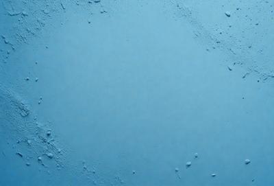 The primary subject of the image is a large, empty blue space. The setting is a blue background, which creates a sense of depth and contrast. The visual style is a close-up of the blue background, emphasizing the color and texture. The colors and mood of the image are predominantly blue, creating a calm and serene atmosphere.