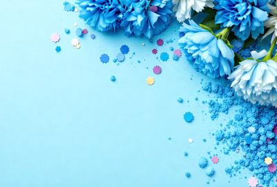 The primary subject of the image is a bouquet of blue flowers, which are the main focus of the scene. The flowers are placed on a blue surface, which adds a vibrant and lively atmosphere to the image. The visual style of the image is a combination of photo and digital art, creating a unique and eye-catching presentation. The dominant colors in the image are blue and white, which contribute to the overall mood of the scene.