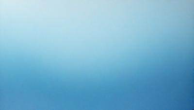 The primary subject of the image is a large, empty blue sky. The setting is a vast, open space with no visible landmarks or objects. The visual style is a natural, untouched landscape. The colors and mood are predominantly blue, creating a serene and peaceful atmosphere.