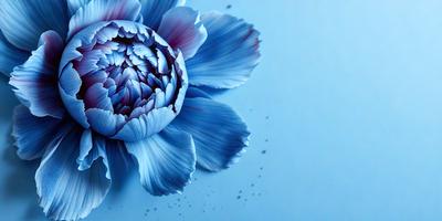 The primary subject of the image is a large, blue flower with purple accents. The flower is prominently displayed in the foreground, with a blue background behind it. The visual style of the image is a combination of photo and digital art, creating a vibrant and eye-catching scene. The dominant colors in the image are blue and purple, giving the flower a striking and elegant appearance.