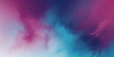 The primary subject of the image is a cloudy sky with a blue and pink hue. The setting is a colorful, cloudy background that creates a vibrant and lively atmosphere. The visual style of the image is a combination of photo and digital art, giving it a unique and artistic appearance. The dominant colors in the image are blue and pink, which create a sense of warmth and tranquility.