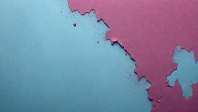 The primary subject of the image is a piece of purple and blue colored paper. The paper appears to be torn or damaged, with a few small holes visible. The setting is a table, and the visual style is a close-up of the paper. The colors and mood of the image are predominantly purple and blue, creating a calm and soothing atmosphere.