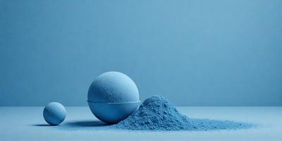 The primary subject of the image is a blue ball, which is the main object in the scene. The setting is a blue background, which creates a visually appealing contrast with the blue ball. The visual style of the image is a photo, capturing the details of the blue ball and its surroundings. The colors and mood of the image are predominantly blue, giving it a calm and serene atmosphere.