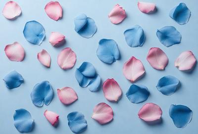 The primary subject of the image is a collection of pink and blue flowers. The flowers are arranged in a visually appealing manner, creating a sense of harmony and beauty. The setting is a blue surface, which serves as a striking backdrop for the flowers. The visual style of the image is a close-up of the flowers, allowing the viewer to appreciate the details and colors of each petal. The colors and mood of the image are predominantly pink and blue, evoking a sense of tranquility