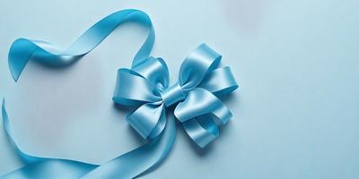 The primary subject of the image is a blue bow, which is prominently displayed on a blue background. The visual style of the image is a close-up of the bow, showcasing its details and texture. The colors and mood of the image are predominantly blue, creating a calm and serene atmosphere.