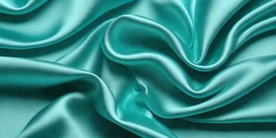 The primary subject of the image is a close-up of a blue fabric, possibly a piece of silk or a similar material. The setting is a dark background, which contrasts with the vibrant blue fabric. The visual style appears to be a close-up of the fabric, showcasing its texture and details. The colors and mood of the image are predominantly blue, creating a calm and serene atmosphere.