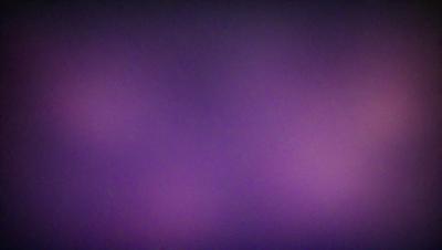 The primary subject of the image is a purple background. The setting is a dark, purple sky, which creates a moody atmosphere. The visual style is a close-up of the purple background, showcasing the richness of the color. The colors and mood of the image are predominantly purple, giving it a dramatic and intense appearance.