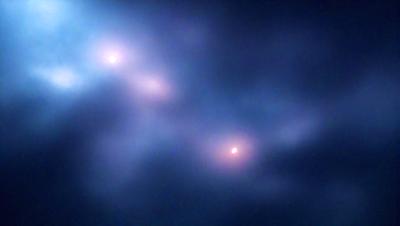 The primary subject of the image is a cloudy sky with a few stars visible. The setting is a dark, cloudy night, and the visual style is a photo. The colors in the image are predominantly dark and moody, with the stars adding a touch of brightness.
