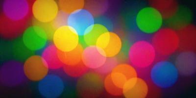The primary subject of the image is a colorful, brightly lit display of lights. The setting is a dark background, which contrasts with the vibrant colors of the lights. The visual style is a combination of a photo and digital art, creating a unique and eye-catching pattern. The colors and mood of the image are predominantly bright and lively, with the lights creating a sense of energy and excitement.