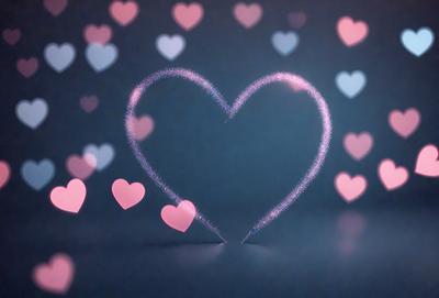 The primary subject of the image is a heart-shaped display made of pink and purple hearts. The heart is placed on a dark background, which contrasts with the bright colors of the hearts. The visual style of the image is a combination of digital art and illustration, creating a unique and eye-catching design. The colors and mood of the image are predominantly pink and purple, giving it a warm and inviting atmosphere.