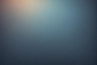 The primary subject of the image is a blue sky with a hazy, foggy appearance. The setting is a cloudy day, and the visual style is a natural, outdoor scene. The colors and mood of the image are predominantly blue and somewhat moody due to the hazy sky.