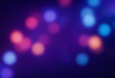 The primary subject of the image is a purple background with a pattern of colored dots. The setting appears to be a dark room, and the visual style is a combination of a photo and digital art. The colors and mood of the image are predominantly purple, with a slightly moody atmosphere.
