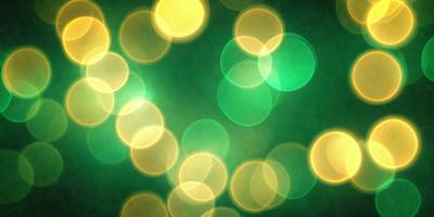 The primary subject of the image is a close-up of a green background with a pattern of yellow and green lights. The setting appears to be a dark room, and the visual style is a combination of a photo and digital art. The dominant colors are green and yellow, creating a warm and inviting atmosphere.