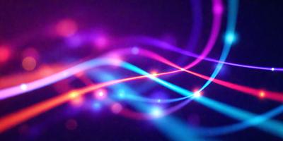 The primary subject of the image is a colorful, swirling pattern of light. The setting is a dark background, which contrasts with the vibrant colors of the light pattern. The visual style appears to be a digital art or illustration, as the light pattern is composed of multiple lines and shapes. The colors and mood of the image are lively and energetic, with the bright colors and swirling patterns creating a sense of movement and dynamism.