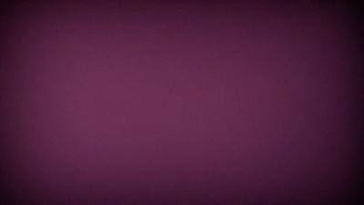 The primary subject of the image is a purple wall. The setting is a room with a purple wall, and the visual style is a close-up of the wall. The colors and mood of the image are predominantly purple, creating a calm and serene atmosphere.