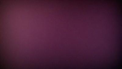 The primary subject of the image is a purple wall. The setting is a room with a purple wall, and the visual style is a photo. The dominant colors are purple and pink, creating a calm and soothing atmosphere.