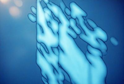 The primary subject of the image is a blue, abstract, and somewhat surreal artwork featuring a hand and a tree. The setting is a blue background, and the visual style appears to be a combination of digital art and illustration. The colors and mood of the image are predominantly blue, creating a calm and serene atmosphere.