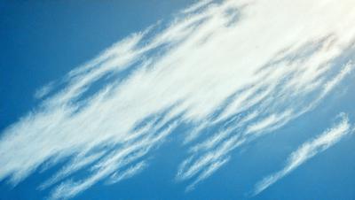 The primary subject of the image is a cloudy blue sky with wispy clouds. The setting is a clear blue sky with a few clouds scattered throughout. The visual style is a natural, outdoor scene with a focus on the cloudy sky. The colors and mood of the image are predominantly blue and serene, creating a peaceful atmosphere.