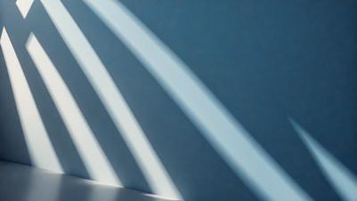The primary subject of the image is a wall with a blue background. The setting is a room with a white wall, and the visual style is a photo. The colors and mood of the image are predominantly blue, creating a calm and serene atmosphere.