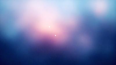 The primary subject of the image is a cloudy sky with a pink hue. The setting is a vast, open space with no visible landmarks or objects. The visual style is a natural, outdoor scene with a focus on the sky and its colors. The dominant colors are pink and purple, creating a serene and calming atmosphere.