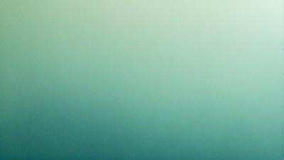 The primary subject of the image is a large, empty wall with a green background. The setting is a room with a plain, unadorned surface. The visual style is a close-up of the wall, showcasing its color and texture. The colors and mood of the image are predominantly green, creating a calm and serene atmosphere.
