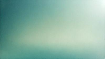 The primary subject of the image is a large, empty, and cloudy sky. The setting is a vast, open space with no visible landmarks or objects. The visual style is a photo, capturing the natural beauty of the sky. The colors and mood of the image are predominantly blue and calm, creating a serene and peaceful atmosphere.