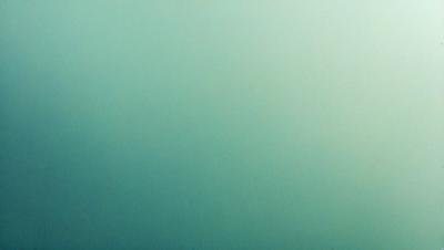 The primary subject of the image is a large, empty, and dark blue space. The setting is a vast, open area with no visible objects or landmarks. The visual style is a close-up of the blue background, which gives the impression of a deep, dark ocean. The colors and mood of the image are predominantly dark and moody, with the blue hue creating a sense of depth and mystery.