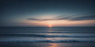 The primary subject of the image is the ocean, with waves crashing on the shore. The setting is a beach, and the visual style is a photo. The colors and mood of the image are predominantly dark, with the sun setting in the distance, creating a serene and dramatic atmosphere.