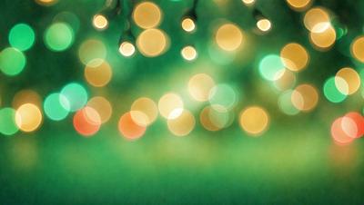 The primary subject of the image is a green field with a pattern of lights, creating a visually appealing and lively atmosphere. The setting is outdoors, with the field being the main focus of the scene. The visual style of the image is a combination of photo and digital art, as it captures the essence of a natural environment with the added element of the light pattern. The colors and mood of the image are predominantly green, with the lights adding a touch of warmth and vibrancy to the