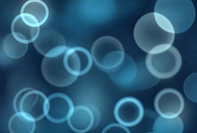 The primary subject of the image is a blue background with a pattern of white circles. The setting appears to be a dark room, and the visual style is a digital art or illustration. The dominant colors are blue and white, creating a calm and serene atmosphere.