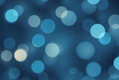 The primary subject of the image is a blue background with a pattern of white circles. The setting appears to be a night sky, with the white circles creating a star-like effect. The visual style of the image is a combination of a photo and digital art, as it features a blend of natural elements and artistic design. The colors and mood of the image are predominantly blue and serene, creating a sense of calmness and tranquility.