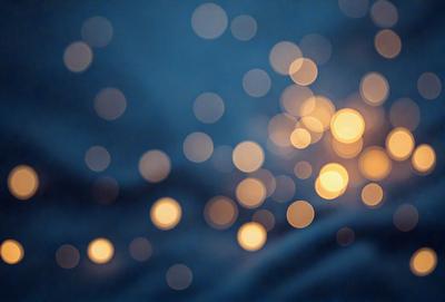 The primary subject of the image is a brightly lit background featuring a pattern of lights. The setting is a dark background, which contrasts with the bright lights. The visual style is a combination of a photo and digital art, creating a unique and eye-catching effect. The colors and mood of the image are predominantly bright and lively, with the lights creating a sense of energy and movement.